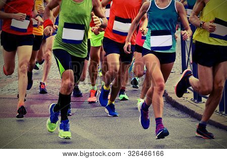 Athletes Runninng On The Road During A Race With Old Toned Effect