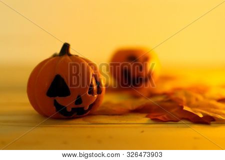 Halloween Pumpkins With Painted Faces On A Wooden Table. Halloween Background. Space For Text. Copy