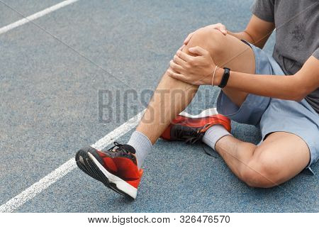 Close Up Of Sport Man Suffering With Pain On Sports Running Knee Injury After Running.injury From Wo