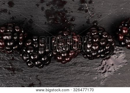 Group Of Five Whole Fresh Black Blackberry Flatlay On Grey Stone