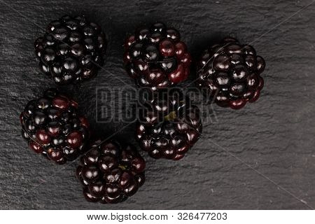Group Of Six Whole Fresh Black Blackberry Flatlay On Grey Stone