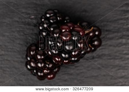 Group Of Four Whole Fresh Black Blackberry Flatlay On Grey Stone