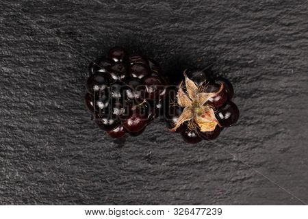 Group Of Two Whole Fresh Black Blackberry Flatlay On Grey Stone