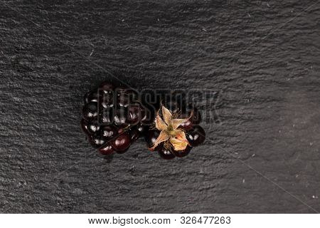Group Of Two Whole Fresh Black Blackberry Flatlay On Grey Stone