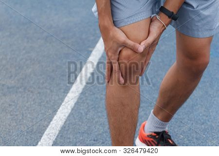 Close Up Of Sport Man Suffering With Pain On Sports Running Knee Injury After Running.injury From Wo