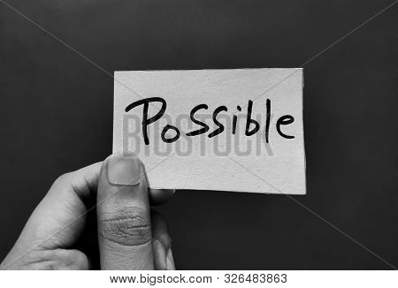 Hand Holding A Paper Card With The Word Possible