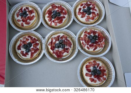 A Container Of Blueberry&strawberry Tarts Ready To Be Served At A National Night Out Celebration.