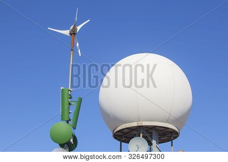 Meteorological Radar Station On The Top Of Sierra De Fuentes, Spain. Antennas, Wind Turbine And Dome