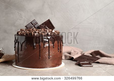 Freshly Made Delicious Chocolate Cake On Marble Table Against Grey Background. Space For Text