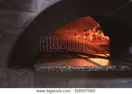 Tasty Stonebaked Pizza Is Ready And Italian Chef Is Removing It From Oven.