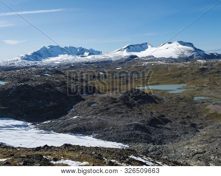 Panoramic View From Krossbu On Glacier Smorstabbreen, Snow-capped Mountains And Blue Lakes In Jotunh