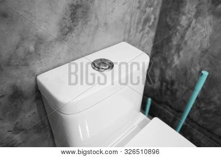 Close Up On A Flush Toilet Button For Cleaning A Toilet.