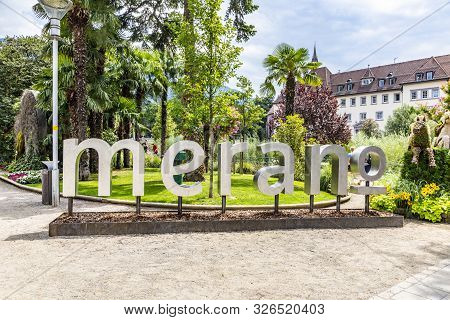 Merano, Italy - August 5, 2019: Glimpse Of The Historic Center Of Merano With Merano In Metal Letter