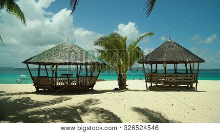 Bungalows And Gazebos On A Sandy Beach With Palm Trees On A Tropical Island, Philippines. Summer And