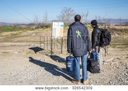 Gevgelija, Macedonia - December 13, 2015  Refugees Standing At The Entrance Of Vinojug Camps Near Th