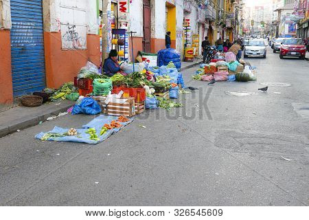 La Paz, Bolivia - July 28, 2019: Tribal Woman Sells Vegetables At The Street In La Paz.