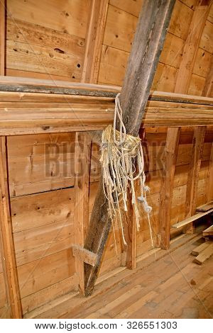Twine From Hay And Straw Bales Are Left Hanging From The Rafter Of A  Barn Haymow.