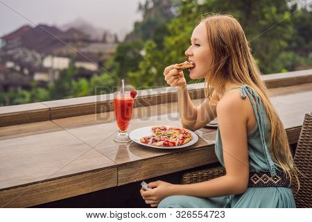 Woman Eating Delicious Strawberry Pizza On A Balinese Tropical Nature Background. Bali Island, Indon