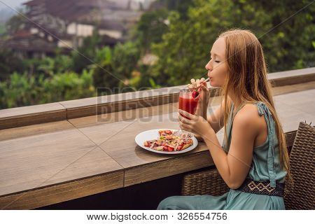 Woman Eating Delicious Strawberry Pizza On A Balinese Tropical Nature Background. Bali Island, Indon