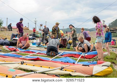Tourists Inflate Catamarans For Rafting On Agidel River. Adventure Team That Prepares To Do Rafting 