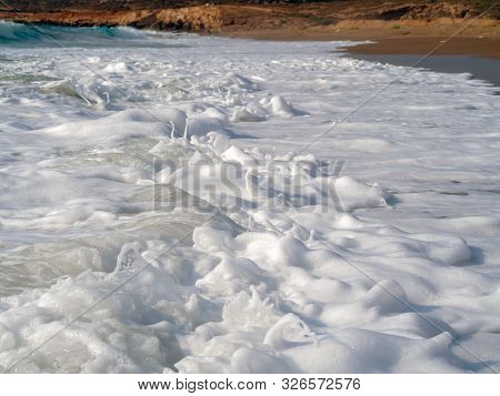 Foam And Waves In The Sea On A Sunny Day. Foam And Waves In The Sea. Powerful Waves Crushing For Bac