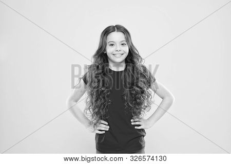 Wind Can Also Damage Hair. Girl Adorable Kid Long Wavy Hair Yellow Background. Strong Persistent Win