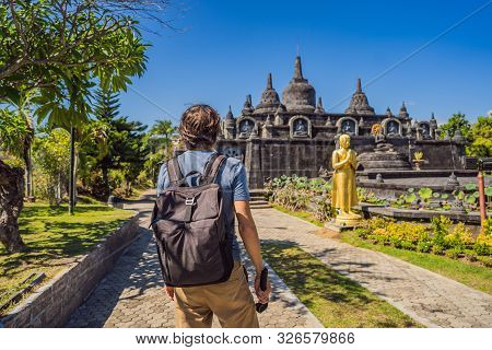 Young Man Tourist In Budhist Temple Brahma Vihara Arama Banjar Bali, Indonesia