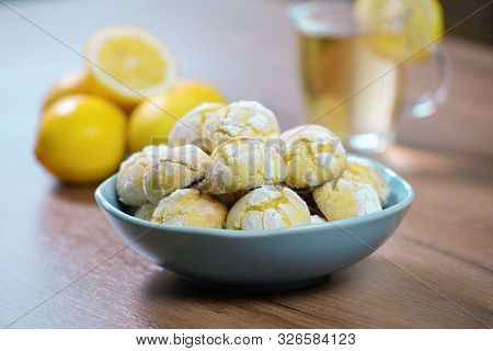 Crinkle Lemon Cookies On Wooden Background. Homemade Sweet And Sour Baking With Tea Cup