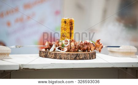 Cook Roasts Kebab With Corn In Moscow At The Fair On Red Square