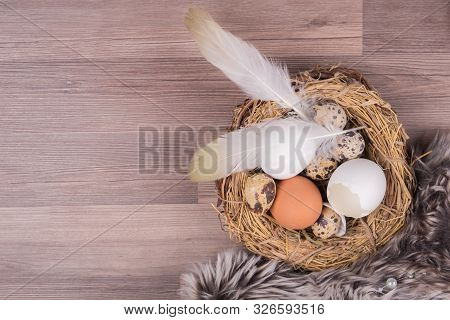 Deco Easter Nest Basket With Eggs Feathers On Wooden Background. Beautiful Decoration Easternest Wit