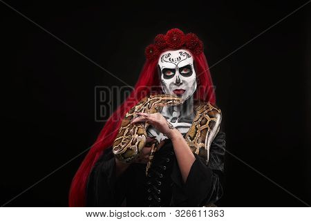 Model With Traditional Sugar Skull Make Up For Halloween Celebration Or Die De Muertos. Woman With R