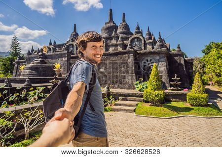 Young Man Tourist In Budhist Temple Brahma Vihara Arama Banjar Bali, Indonesia Follow Me Concept