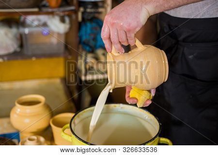 Professional Male Potter Preparing Ceramic Wares For Burning In Pottery Kiln With Milk - Old Russian
