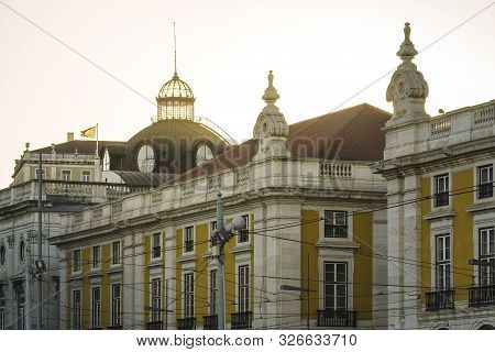 Glass Dome Of The Lisbon City Hall Building At Sunset With The Portuguese Flag Waving Over The Build