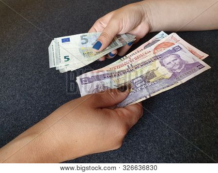 Women Hands Exchanging European Banknotes And Honduran Money