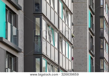 Closeup Of Glass Balconies With Few Bright Flowers