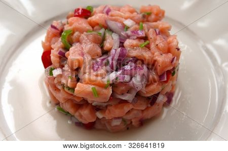 Salmon Fish Ceviche Cooking Ring Serving On White Plate Close Up. Traditional Peruvian Dish