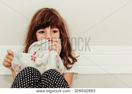 Little Girl Holding Her Blanket, Worried About Something. Sitting In Her Room. International Childer