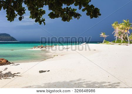 Paradise Beach In Thailand During Storm With Tall Palms