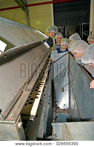 Kaliningrad, Russia - September 27, 2019: Children Watch The Production Of Pebble Chocolate. Childre