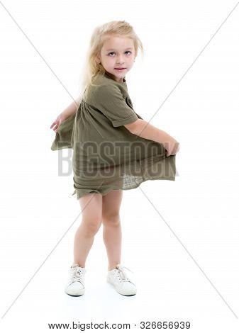 Beautiful Little Girl In A Dress Is Spinning. Concept Of Happy Childhood, Dancing, Holidays. Isolate