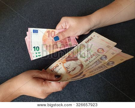 Women Hands Exchanging European Banknotes And Uruguayan Money