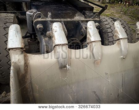 Bucket Of A Large Excavator. Steel Teeth Are Photographed Close-up. Horizontal Frame