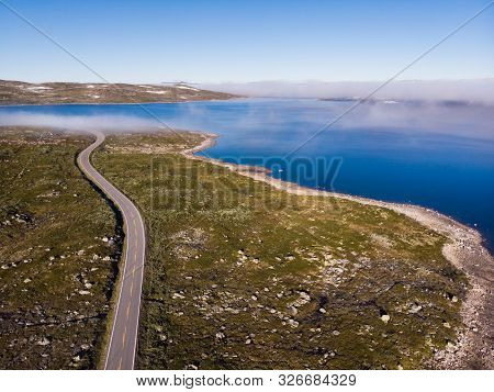 Aerial View. Road Crossing Hardangervidda Mountain Plateau, Clouds Over Lakes, Morning Time. Norway 