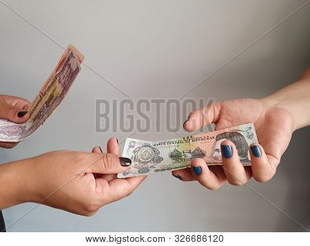 Women Hands Paying And Receiving Honduran Money