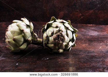 Artichokes On Rustic Dark Background. Fresh Organic Artichoke Flower.