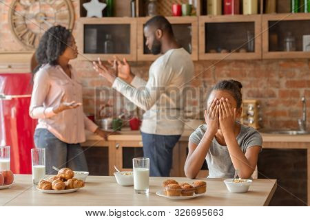 Family Problems Concept. African American Little Girl Covering Her Eyes With Hands, Parents Figting 
