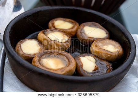 Close Up Mushrooms Baked With Cheese Suluguni On Ketsi. Georgian Cousine.