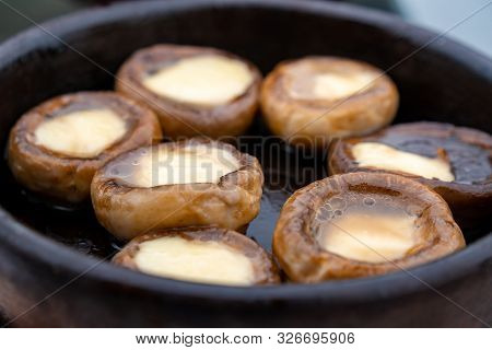 Close Up Mushrooms Baked With Cheese Suluguni On Ketsi. Georgian Cousine.