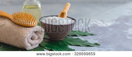 Body Spa Treatment Bamboo Brush With Bathtowel On Green Tropical Leaf, Concrete Background